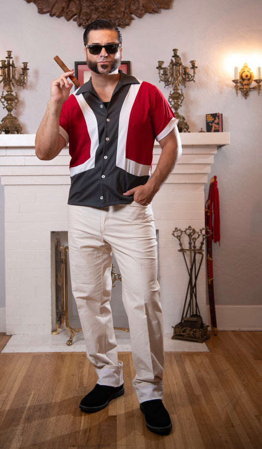 Man wearing Greaser Jeans styled in vintage high-rise denim, posing beside a wall